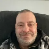 Man in his forties at work, smiling